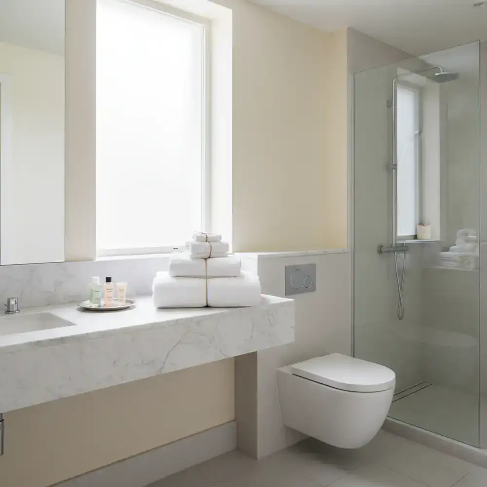 Spotless rental property bathroom with folded towels
